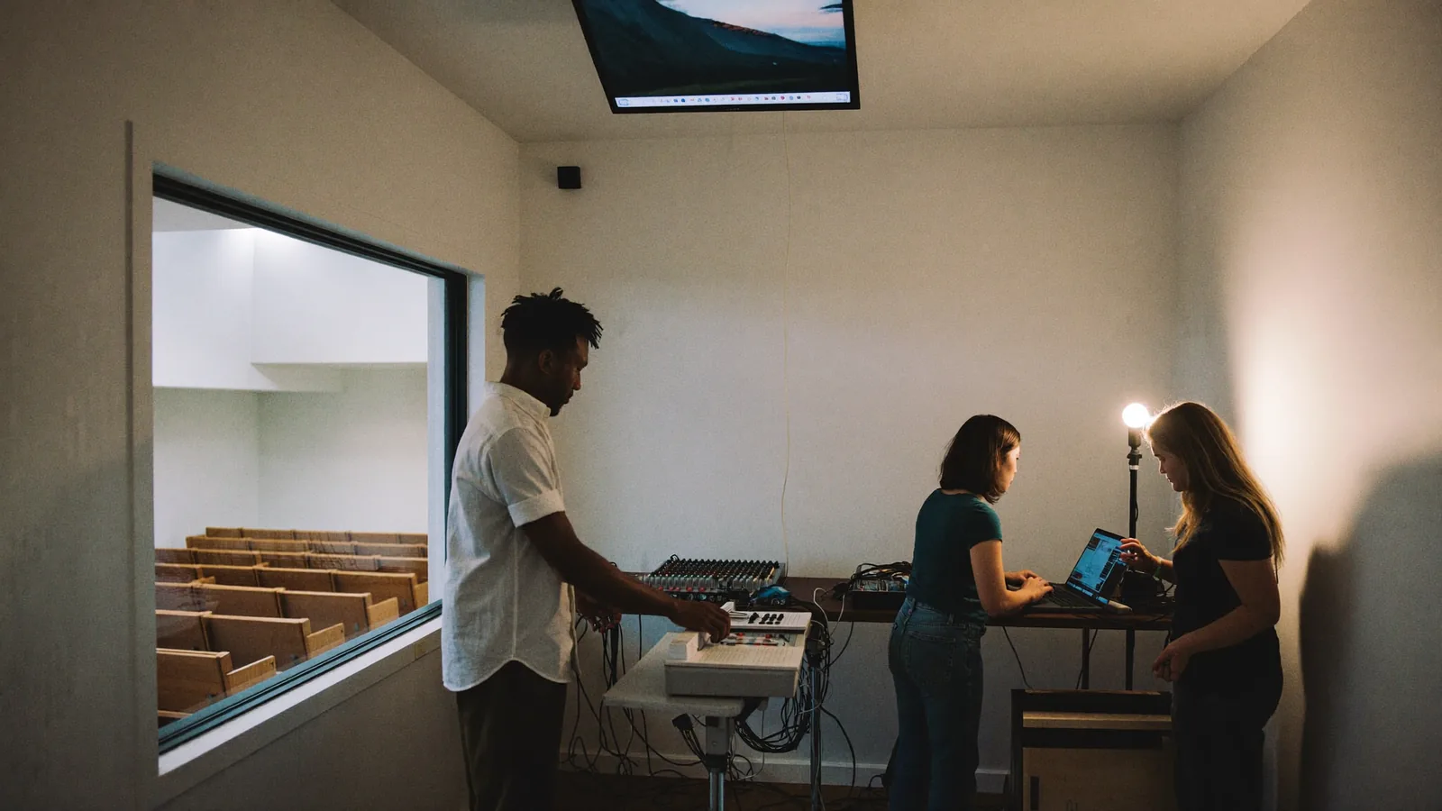 Volunteers running the sound desk and live stream from the media booth